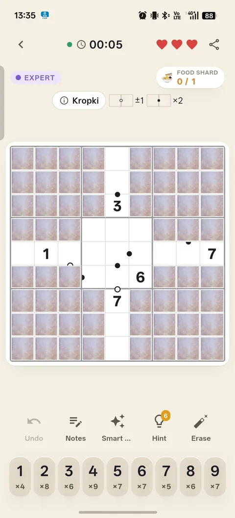 A Kropki board: white and black dots sitting between cells, including between covered ones